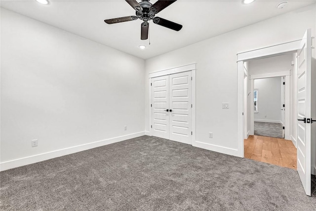 unfurnished bedroom with carpet floors, ceiling fan, and a closet