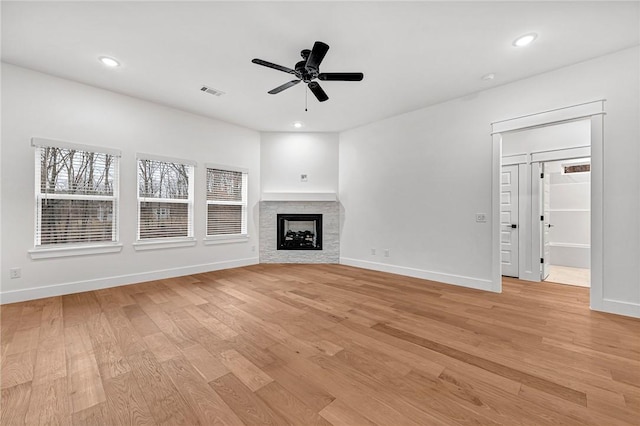 unfurnished living room with ceiling fan and light hardwood / wood-style floors