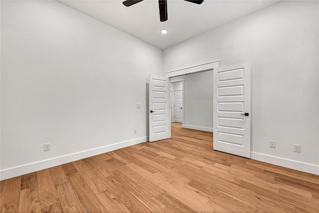 unfurnished bedroom with ceiling fan and light hardwood / wood-style floors