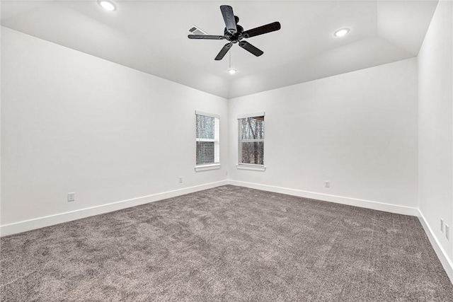 carpeted empty room featuring vaulted ceiling and ceiling fan