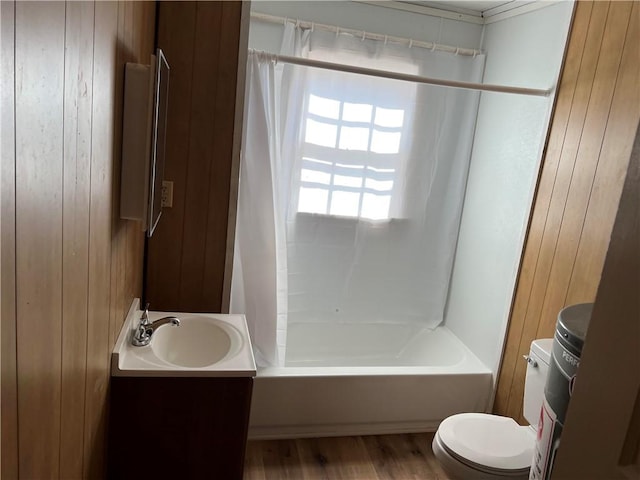 full bathroom featuring shower / bathtub combination, vanity, toilet, and wood walls