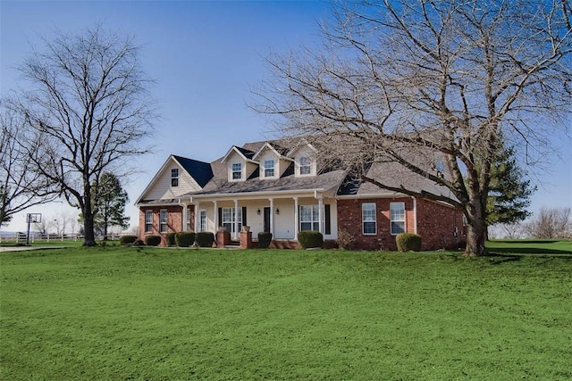 new england style home featuring a porch and a front lawn