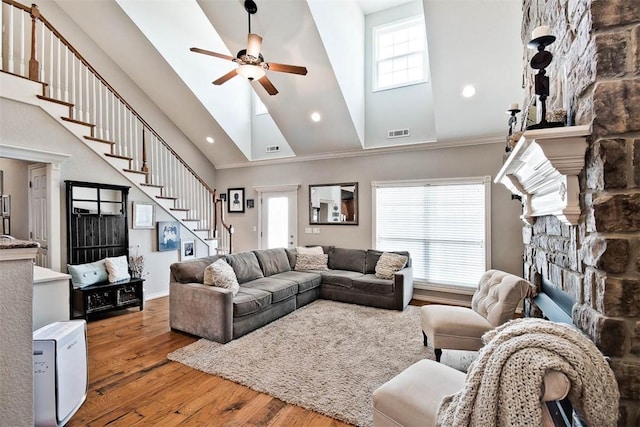 living room with high vaulted ceiling, hardwood / wood-style floors, and a wealth of natural light