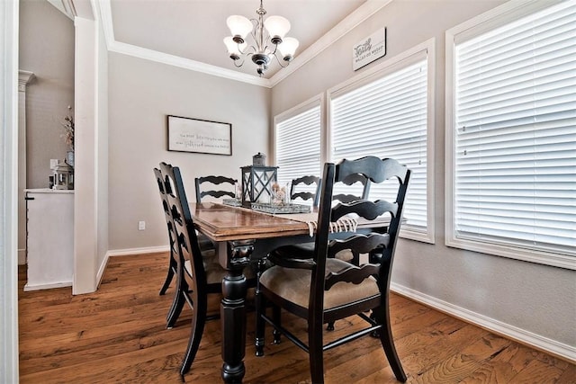 dining area with an inviting chandelier, hardwood / wood-style flooring, and ornamental molding