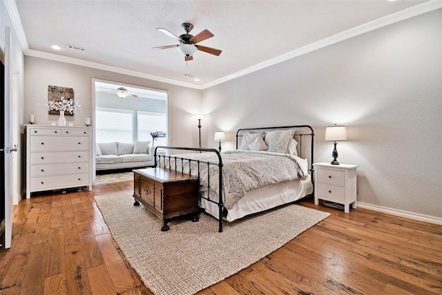 bedroom with ornamental molding, light hardwood / wood-style floors, and ceiling fan