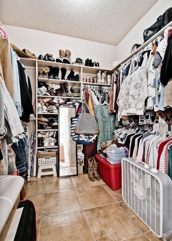 walk in closet featuring tile patterned flooring