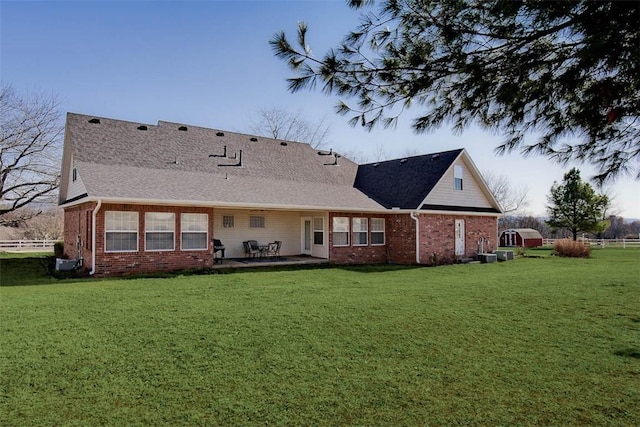 back of house featuring a patio and a lawn