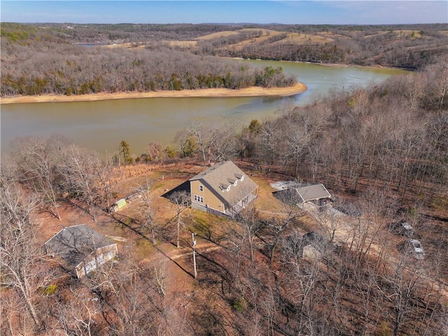 birds eye view of property with a water view and a wooded view