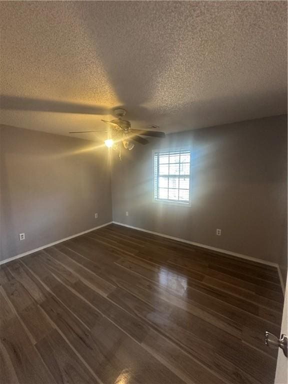 unfurnished room with dark hardwood / wood-style flooring, a textured ceiling, and ceiling fan