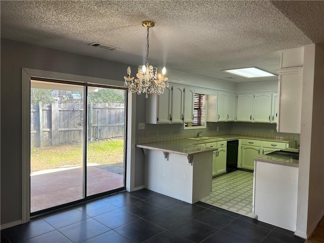 kitchen with white cabinetry, decorative light fixtures, kitchen peninsula, and an inviting chandelier