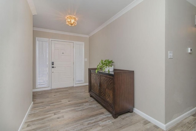 foyer entrance with ornamental molding and light hardwood / wood-style floors