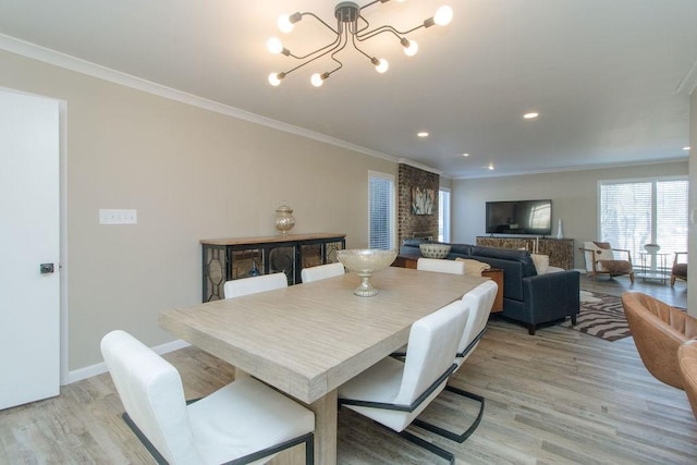 dining room featuring an inviting chandelier, ornamental molding, and light wood-type flooring