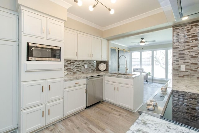 kitchen featuring sink, ornamental molding, white cabinets, and appliances with stainless steel finishes