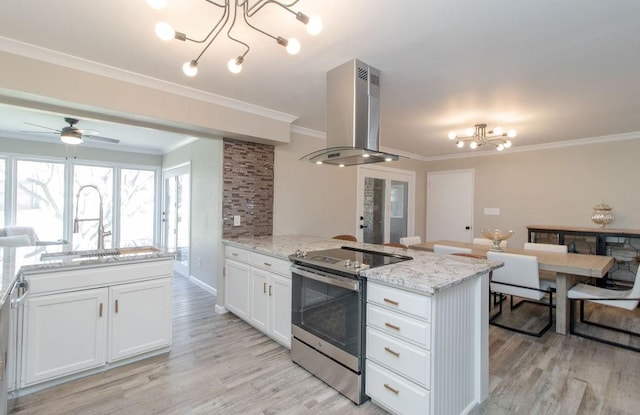 kitchen featuring sink, white cabinetry, light stone counters, island exhaust hood, and stainless steel electric stove