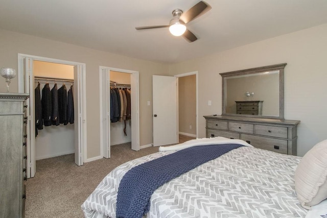 carpeted bedroom with multiple closets and ceiling fan