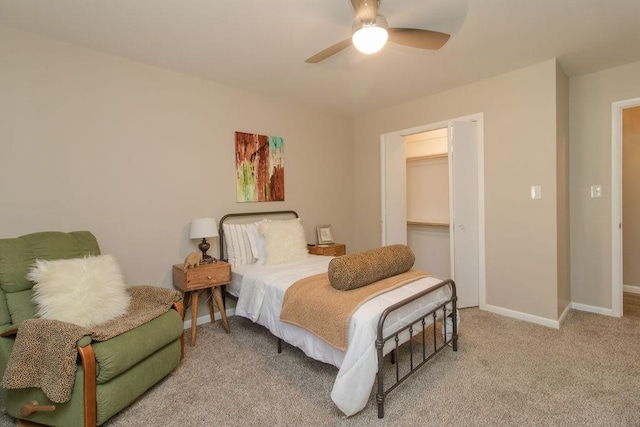 bedroom with light colored carpet, ceiling fan, and a closet