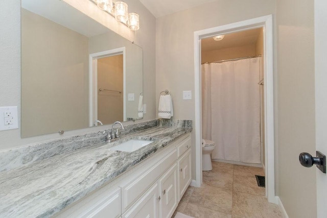 bathroom with vanity, tile patterned floors, and toilet