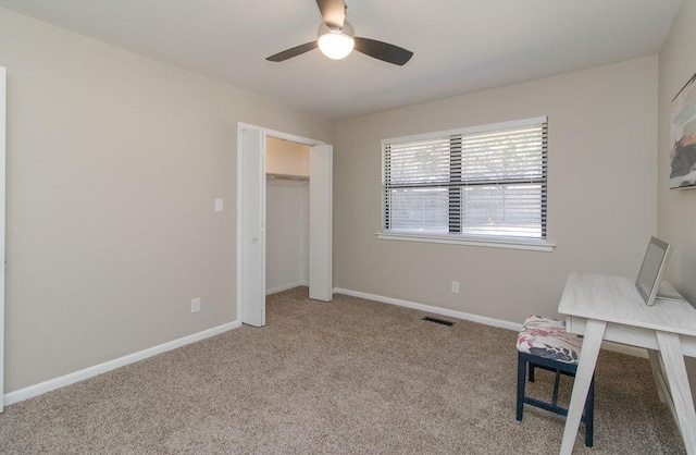 interior space with light carpet and ceiling fan