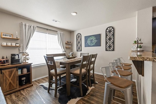 dining area with dark hardwood / wood-style floors