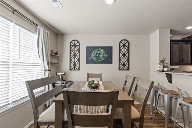 dining area with dark hardwood / wood-style floors