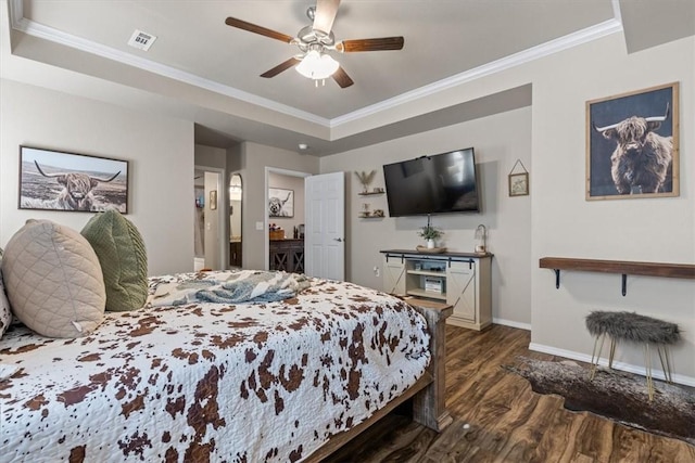 bedroom with dark wood-type flooring, ceiling fan, crown molding, and a raised ceiling