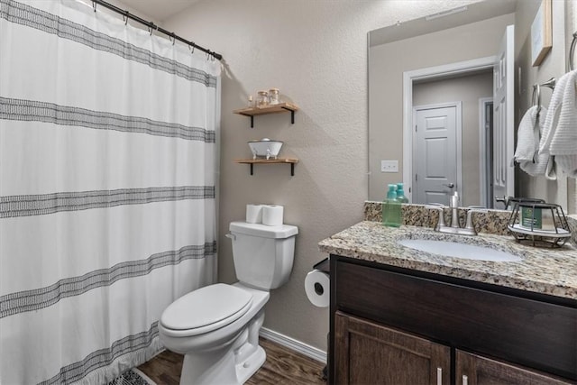 bathroom featuring vanity, toilet, and hardwood / wood-style floors