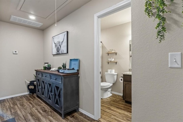 bathroom with vanity, wood-type flooring, and toilet