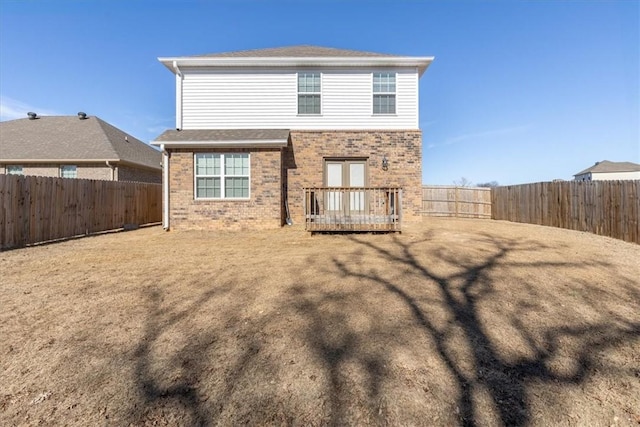 back of house featuring a wooden deck