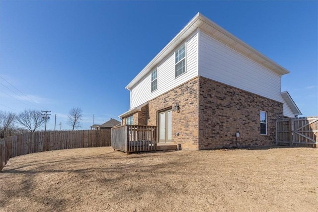 view of side of property with a yard and a deck