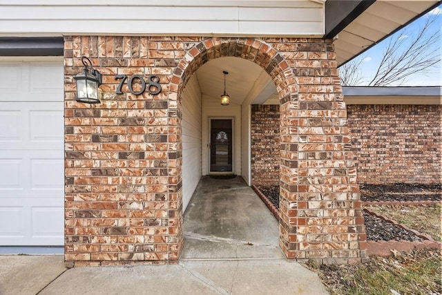 doorway to property with a garage