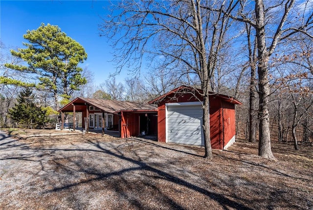 single story home featuring a garage and an outdoor structure