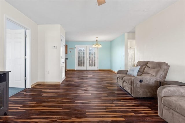 living room with dark hardwood / wood-style flooring and french doors