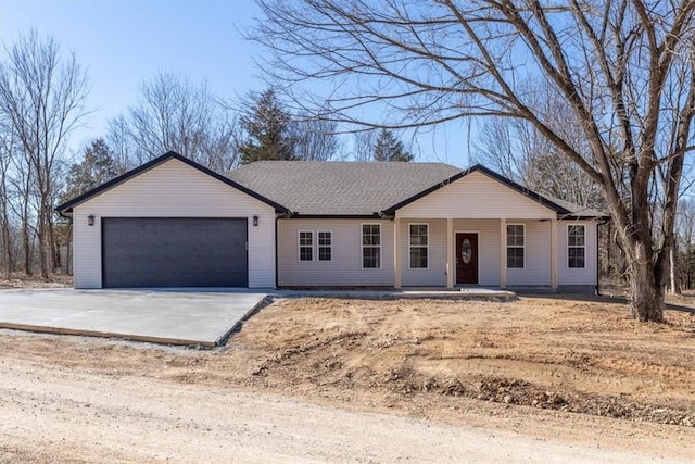 single story home featuring an attached garage, concrete driveway, and a porch