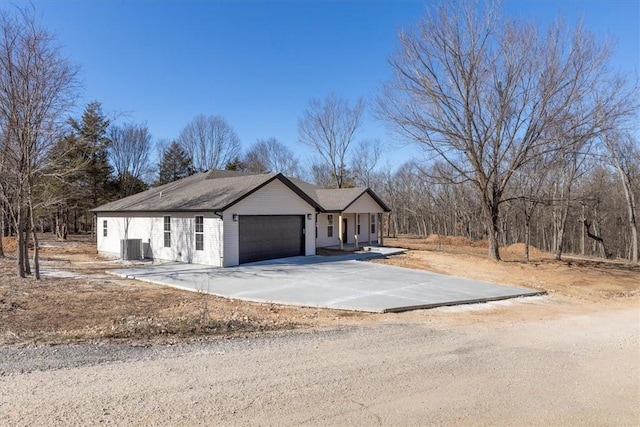 view of side of property with a garage and driveway