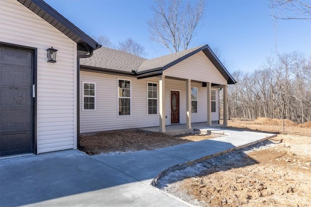 view of front facade with a garage and covered porch