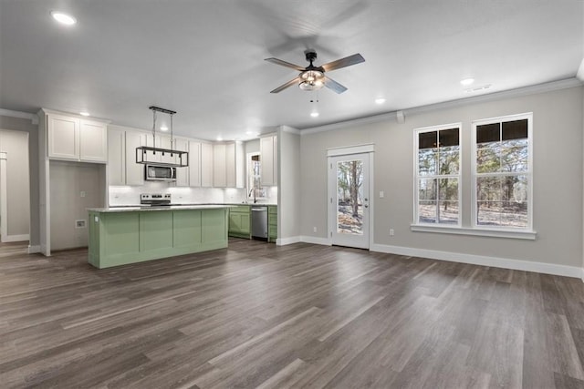 kitchen featuring pendant lighting, green cabinets, stainless steel appliances, white cabinets, and a kitchen island