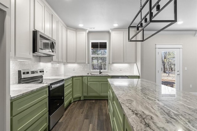 kitchen with light stone countertops, appliances with stainless steel finishes, white cabinets, and green cabinetry