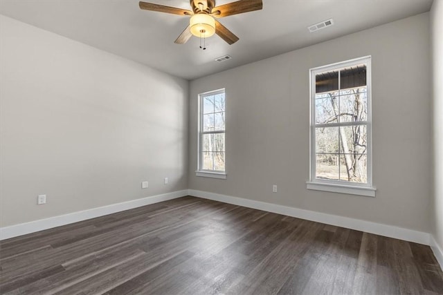 spare room with ceiling fan and dark hardwood / wood-style flooring