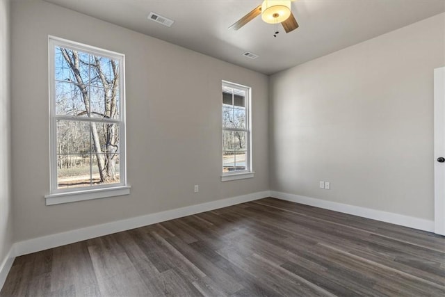 spare room featuring dark hardwood / wood-style floors and ceiling fan