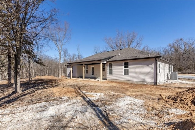 back of property with cooling unit and a patio area