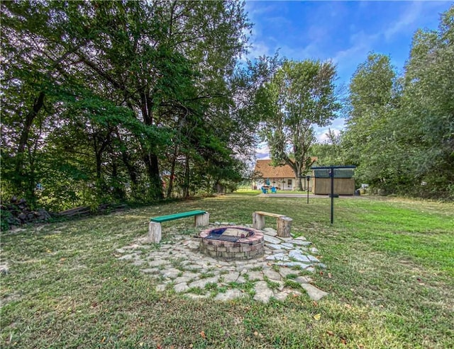 view of yard featuring a shed and a fire pit