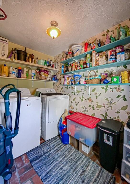 clothes washing area featuring washer and dryer and a textured ceiling