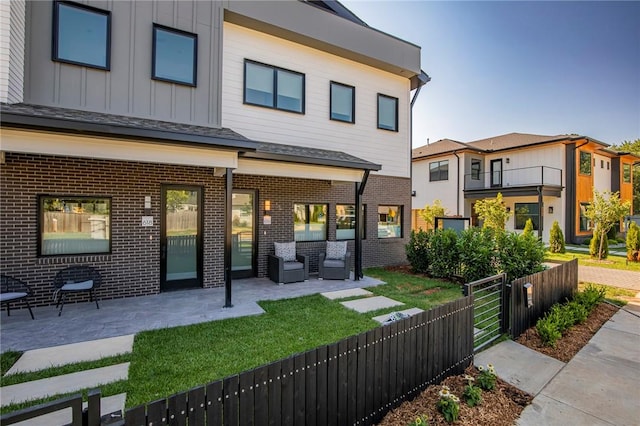 rear view of property featuring a patio area