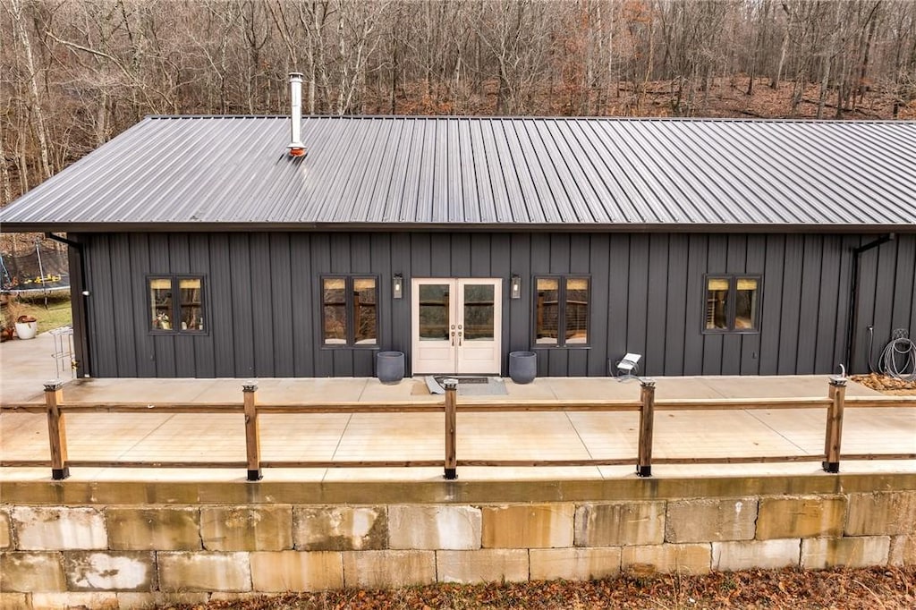 back of property with a patio area and a trampoline