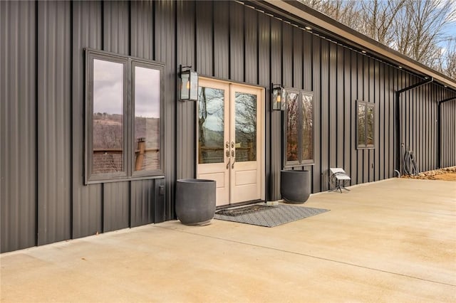 view of exterior entry with french doors and a patio