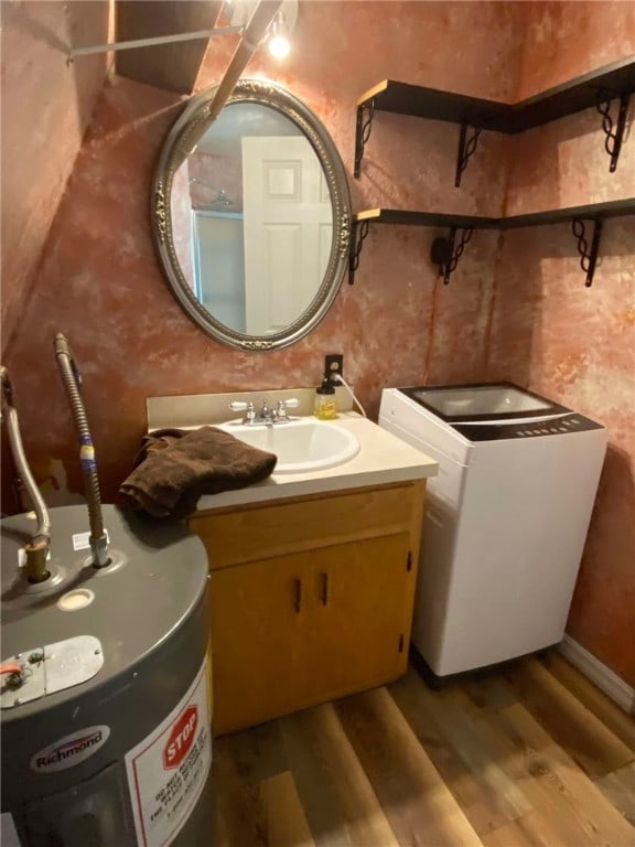 bathroom featuring wood-type flooring, sink, and water heater