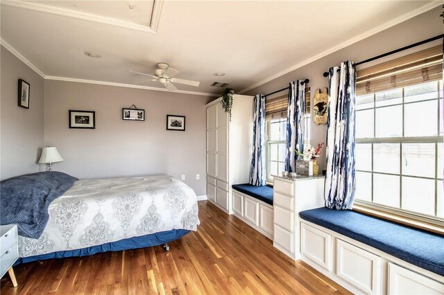 bedroom featuring ornamental molding, wood-type flooring, and ceiling fan