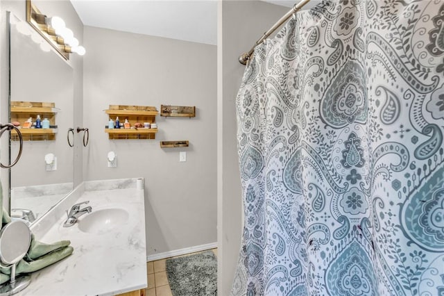 bathroom featuring tile patterned flooring, vanity, and curtained shower