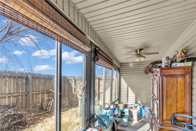 unfurnished sunroom featuring ceiling fan