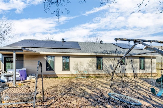 back of house with solar panels